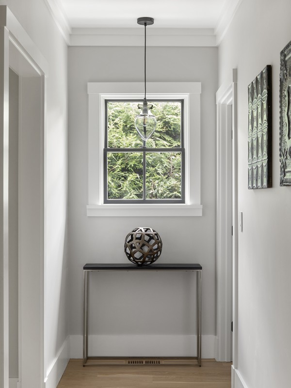 hallway with accent furniture and pendant © Jacob Lilley Architects Needham, MA